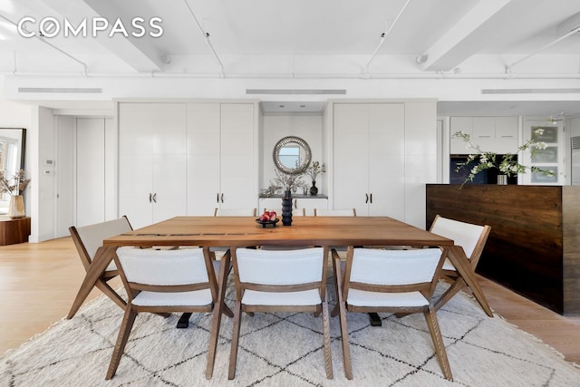 dining space featuring light wood-style flooring