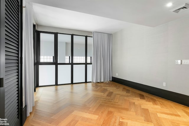 spare room featuring baseboards and visible vents