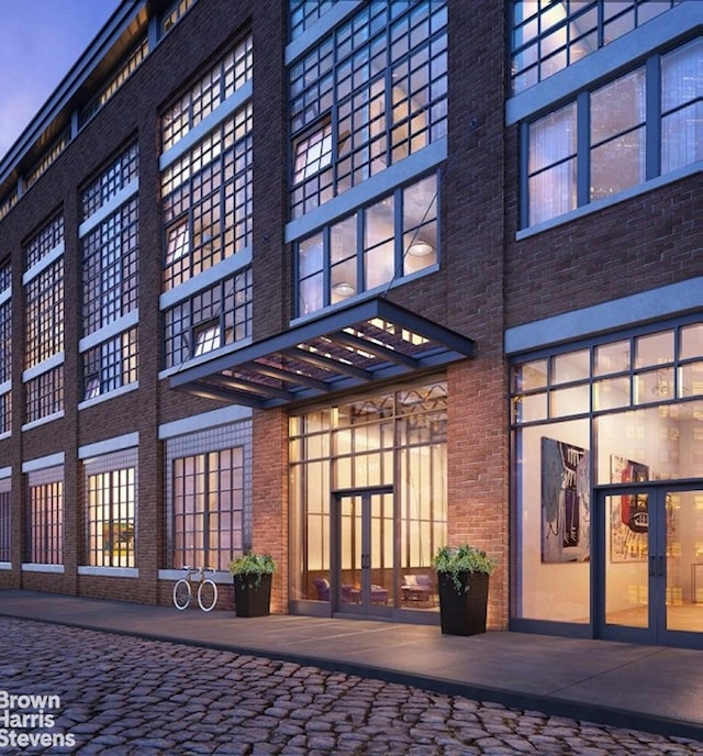 exterior space with french doors and brick siding