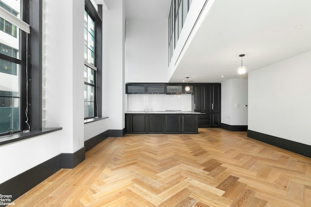 interior space with baseboards and a high ceiling