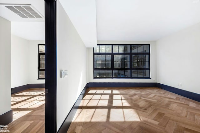 unfurnished room featuring visible vents and baseboards