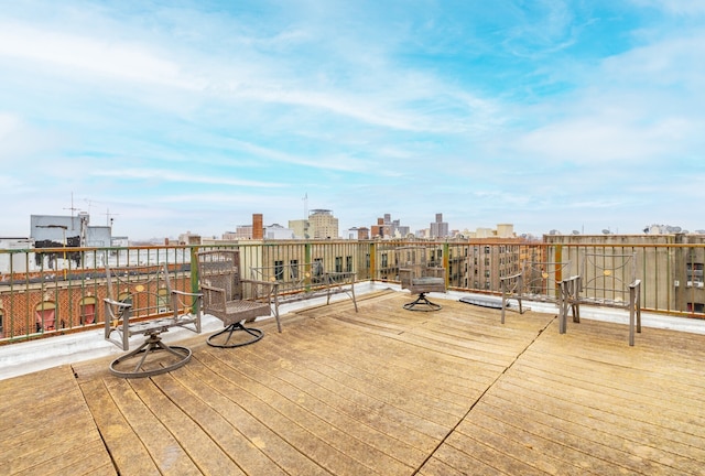 wooden deck featuring a view of city