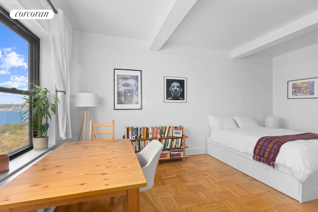 bedroom featuring multiple windows, beam ceiling, and a water view