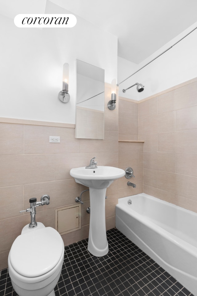 bathroom with shower / bath combination, tile walls, and tile patterned flooring