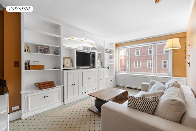 living room featuring light floors and built in shelves