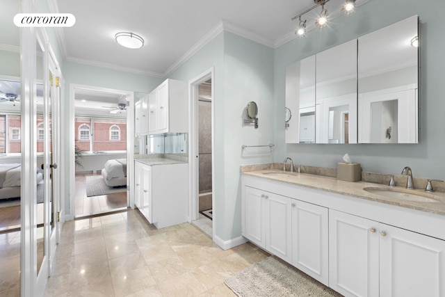 ensuite bathroom with a sink, crown molding, ceiling fan, and connected bathroom