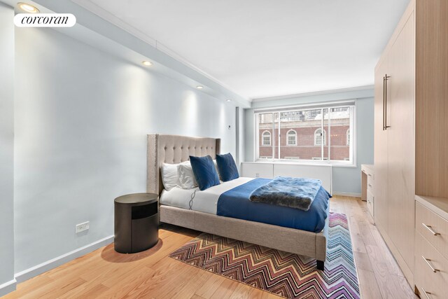bedroom with baseboards, recessed lighting, and light wood-style flooring