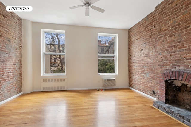 unfurnished living room with baseboards, a healthy amount of sunlight, and radiator