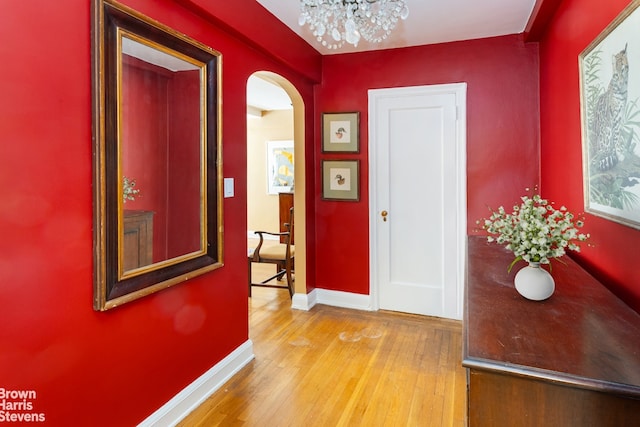 414 E 52nd St Unit 10E, New York City, NY 10022 - foyer with arched walkways, hardwood / wood-style floors, baseboards, and a chandelier