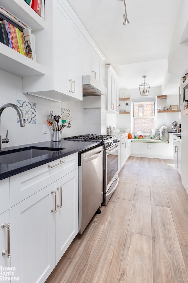 kitchen with dishwashing machine, open shelves, decorative backsplash, white cabinets, and under cabinet range hood