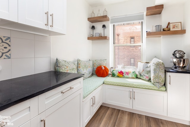 414 E 52nd St Unit 10E, New York City, NY 10022 - kitchen featuring open shelves, white cabinets, and wood finished floors