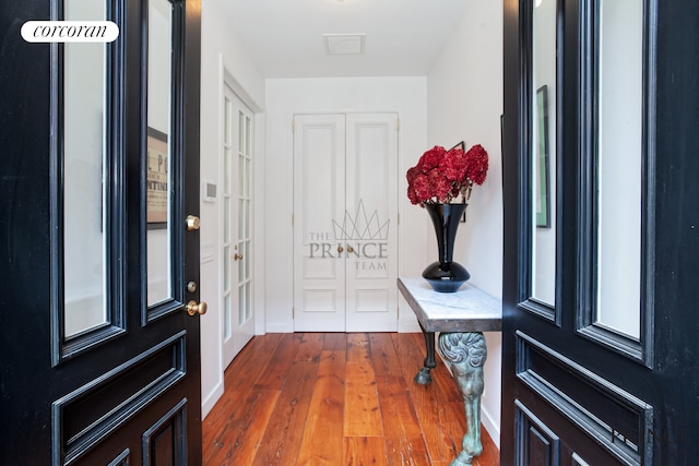 entrance foyer with wood finished floors and visible vents