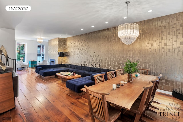 dining room with an inviting chandelier, hardwood / wood-style flooring, recessed lighting, and visible vents