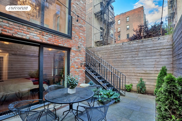 view of patio with stairs and outdoor dining area