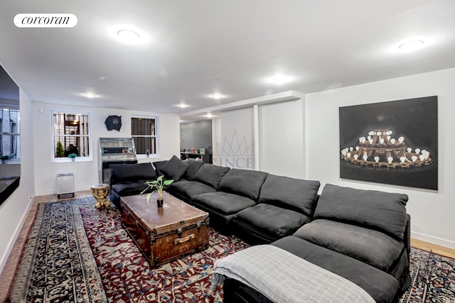 living area with wood finished floors, visible vents, and baseboards