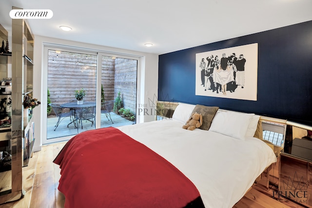 bedroom with access to exterior, wood finished floors, and visible vents
