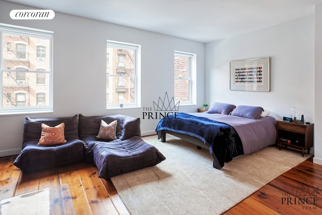 bedroom featuring baseboards and hardwood / wood-style flooring