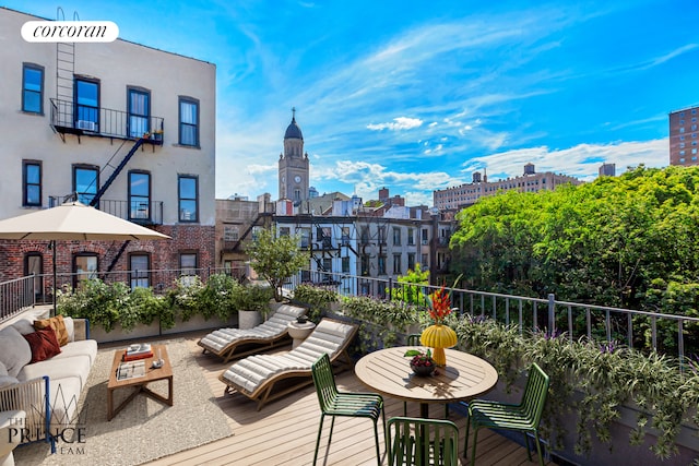 wooden deck with a city view and an outdoor living space