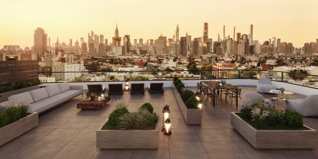 28 Herbert St Unit 4C, New York City, NY 11222 - patio terrace at dusk featuring an outdoor living space with a fire pit and a view of skyline