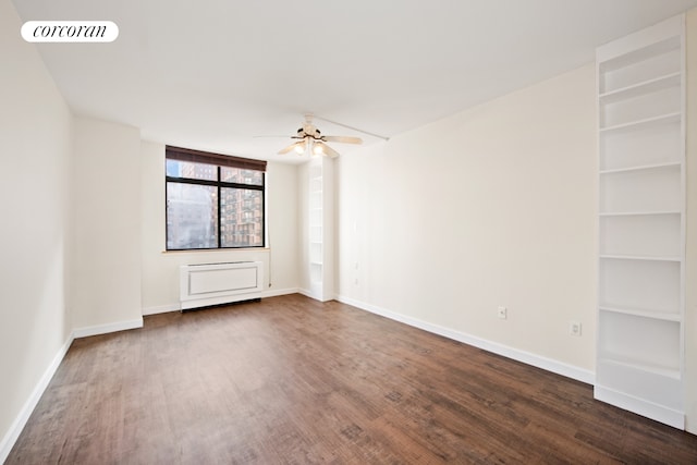 spare room featuring dark wood-type flooring, baseboards, visible vents, and ceiling fan