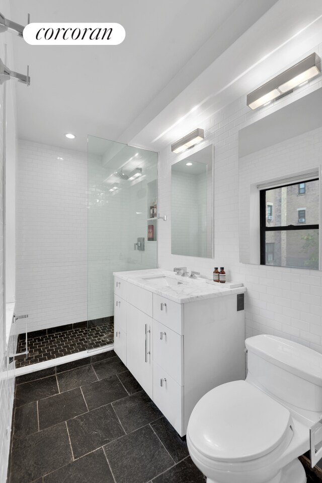 30 W 86th St Unit 2B, New York City, NY 10024 - full bathroom with toilet, a stall shower, vanity, tile walls, and recessed lighting