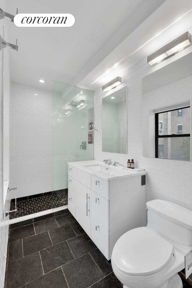 30 W 86th St Unit 2B, New York City, NY 10024 - bathroom with vanity, walk in shower, tile walls, and recessed lighting