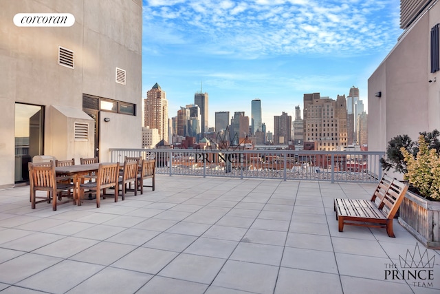 view of patio with visible vents and a city view