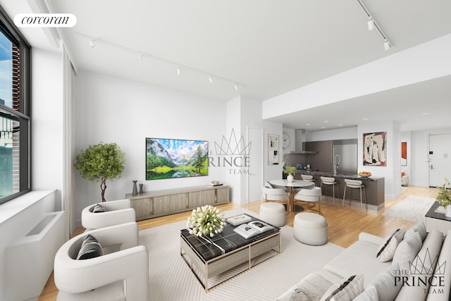 living room with track lighting, a wealth of natural light, visible vents, and light wood finished floors