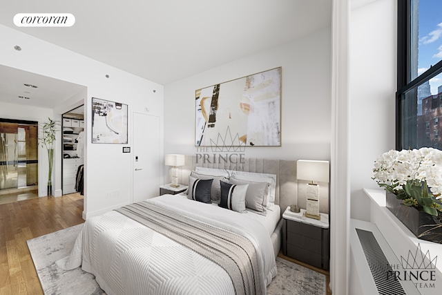 bedroom with wood finished floors and visible vents