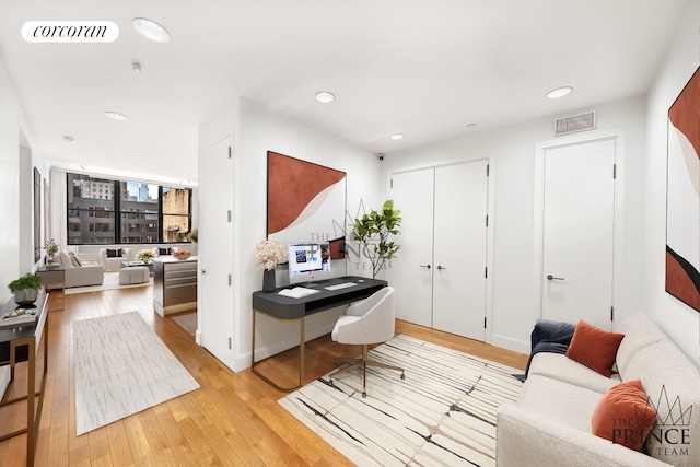 office with light wood-style flooring, recessed lighting, and visible vents