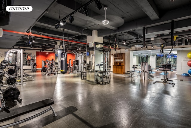 exercise room featuring water heater and visible vents