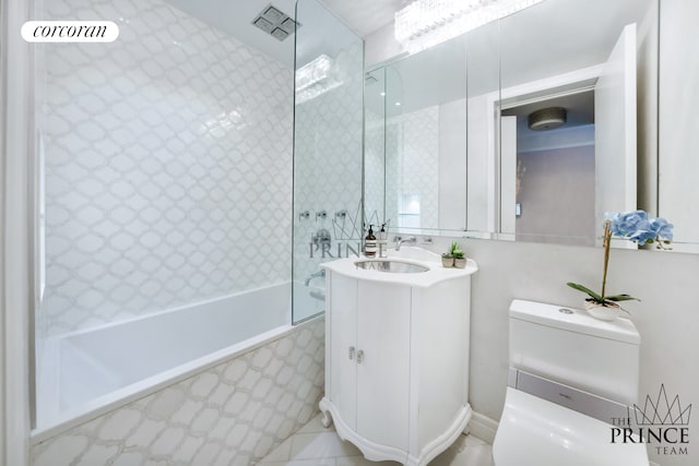 full bath with vanity, toilet, and a combined bath / shower with marble appearance