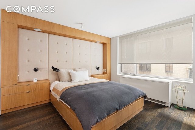 110 E 71st St Unit 3, New York City, NY 10021 - bedroom with dark wood-style floors and radiator heating unit