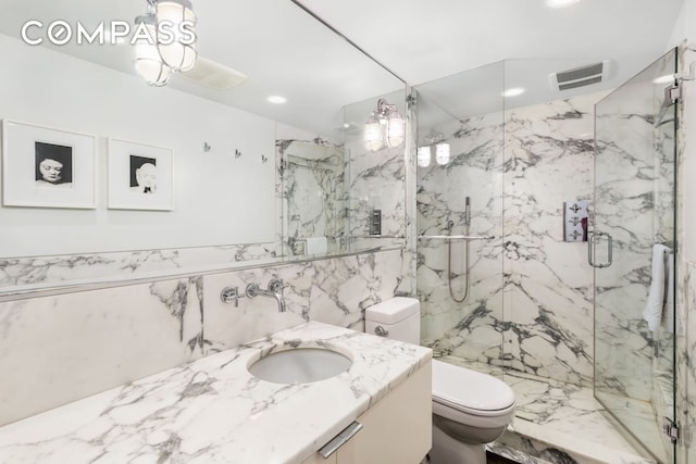110 E 71st St Unit 3, New York City, NY 10021 - bathroom with toilet, a marble finish shower, vanity, tile walls, and recessed lighting
