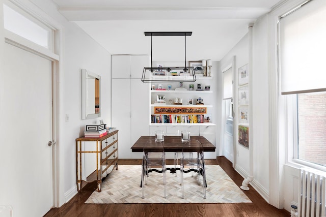 home office featuring baseboards, parquet floors, and radiator heating unit