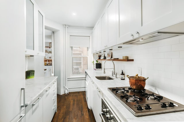 kitchen featuring wall oven, white cabinets, stainless steel gas stovetop, and a sink