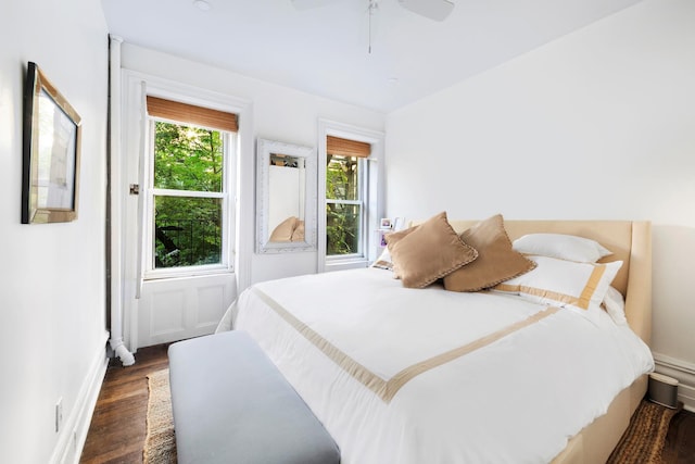 bedroom featuring baseboards, a ceiling fan, and wood finished floors