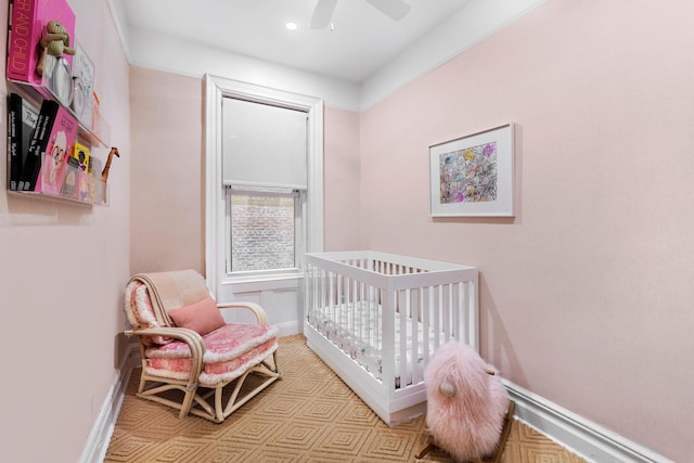 bedroom featuring a nursery area, baseboards, recessed lighting, and a ceiling fan