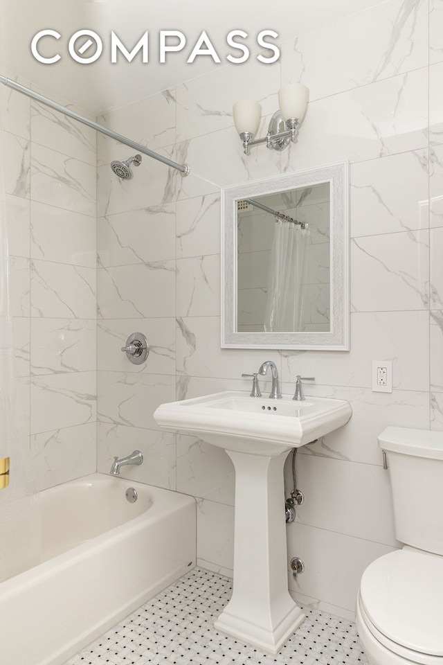 132 E 35th St Unit 7H, New York City, NY 10016 - bathroom with shower / bathtub combination with curtain, toilet, tile walls, and a sink