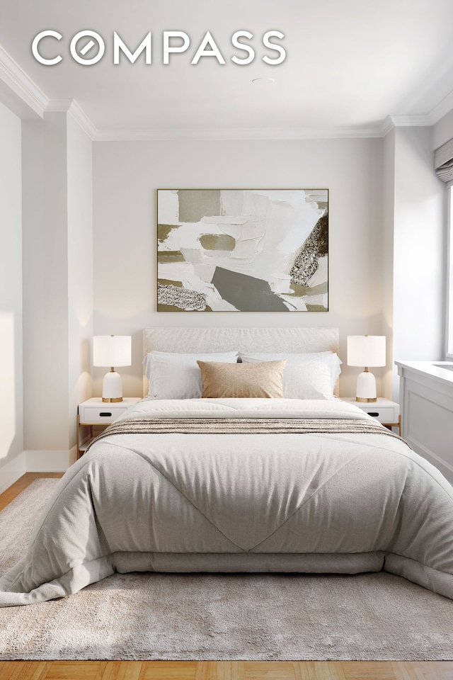 132 E 35th St Unit 7H, New York City, NY 10016 - bedroom with ornamental molding, baseboards, and wood finished floors