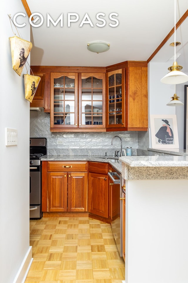132 E 35th St Unit 7H, New York City, NY 10016 - kitchen featuring appliances with stainless steel finishes, a sink, decorative backsplash, and brown cabinetry