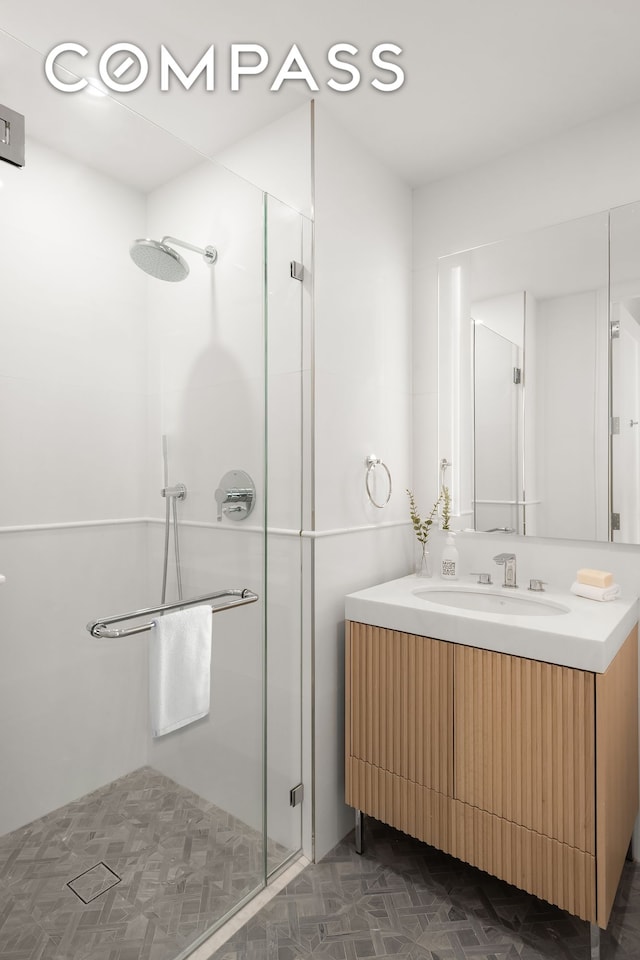 full bathroom featuring vanity and a shower stall