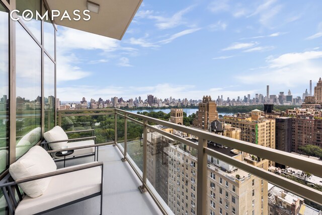 balcony with a view of city and a water view