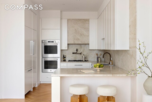 kitchen with white cabinets, modern cabinets, and stainless steel appliances