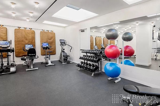 gym featuring baseboards and visible vents