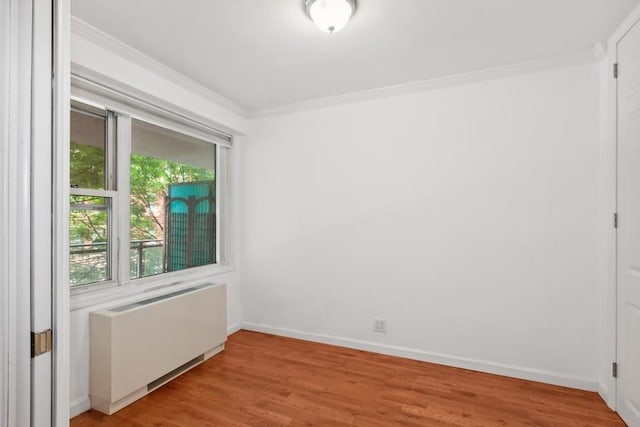 400 E 77th St Unit 3-A, New York City, NY 10075 - empty room featuring radiator heating unit, crown molding, and light wood-type flooring