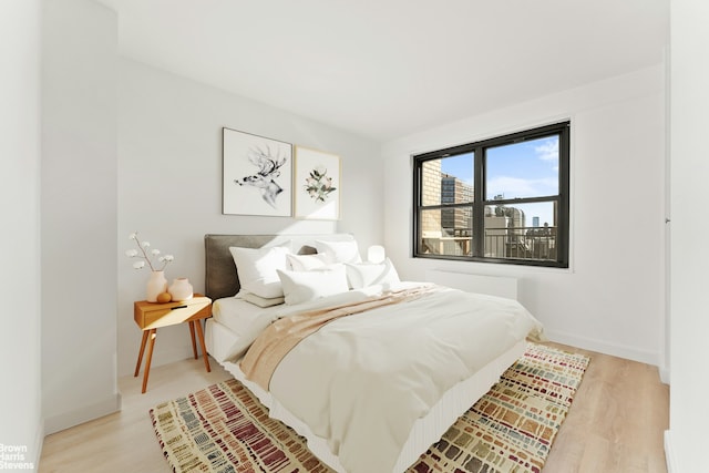 bedroom featuring light wood-type flooring and baseboards