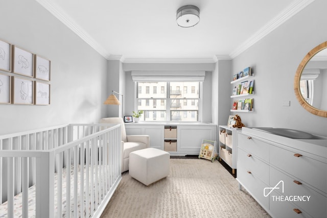 bedroom with a crib and ornamental molding
