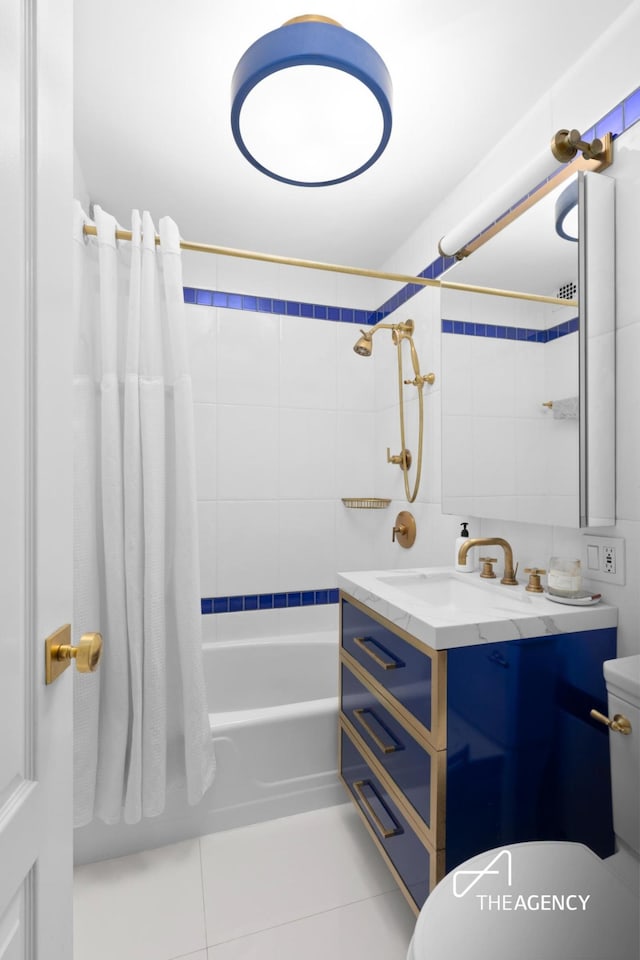 bathroom featuring shower / tub combo, toilet, vanity, and tile patterned floors