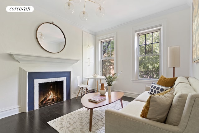 living room featuring visible vents, baseboards, ornamental molding, a warm lit fireplace, and wood finished floors